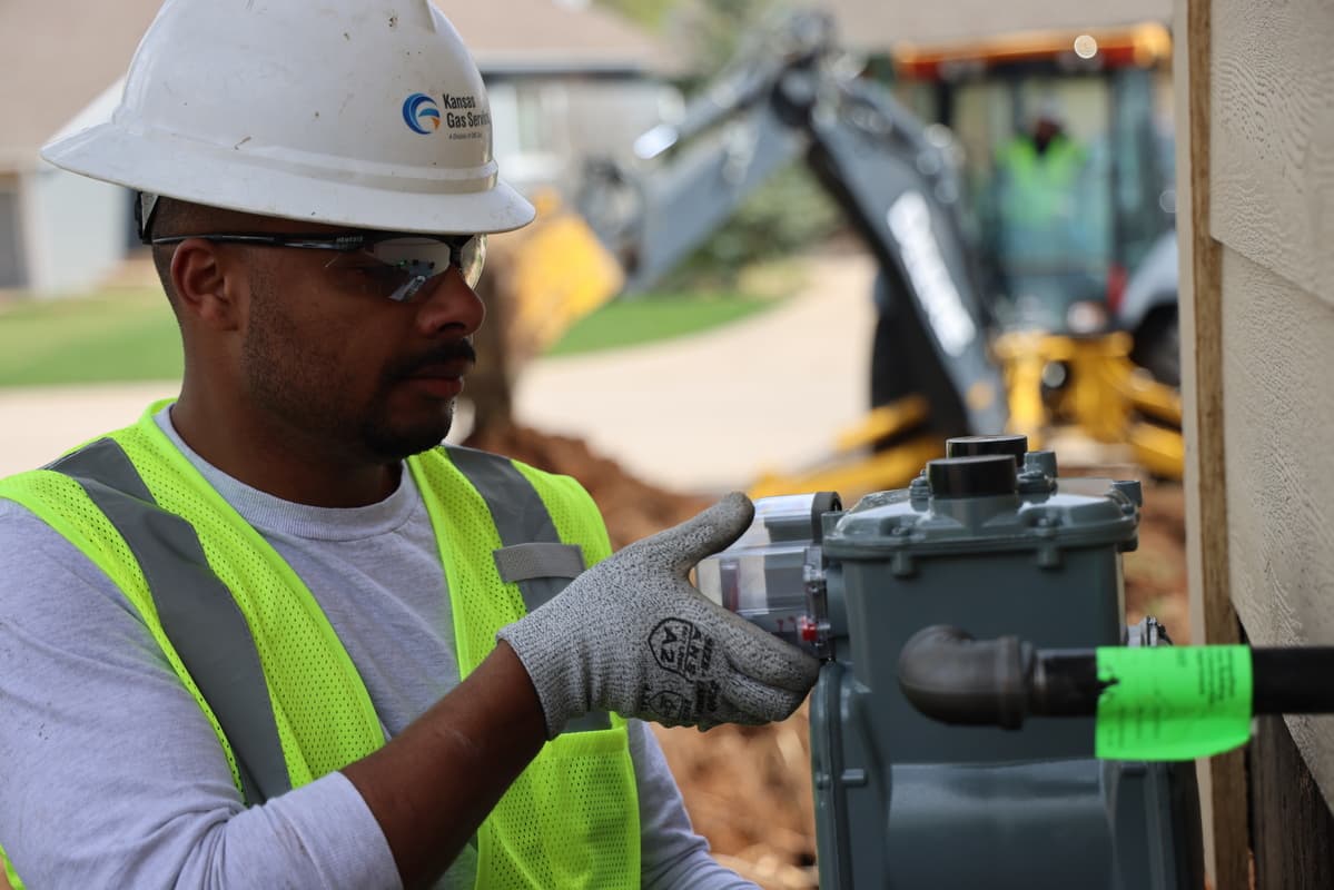 Kanas Gas Service employee installing natural gas meter